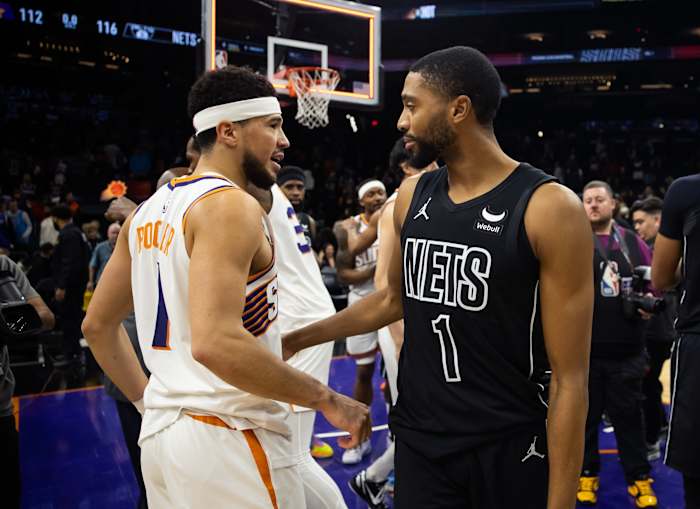 Phoenix Suns guard Devin Booker greets Brooklyn Nets forward Mikal Bridges
